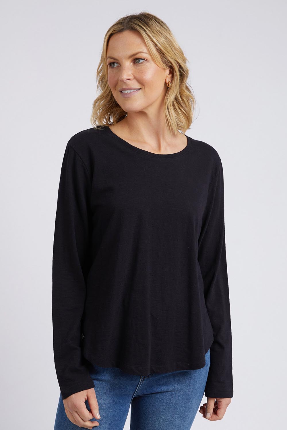 A model wearing the Fundamental Everyday Cotton Long Sleeve Tee in colour Black (Black), from the front, cropped image
