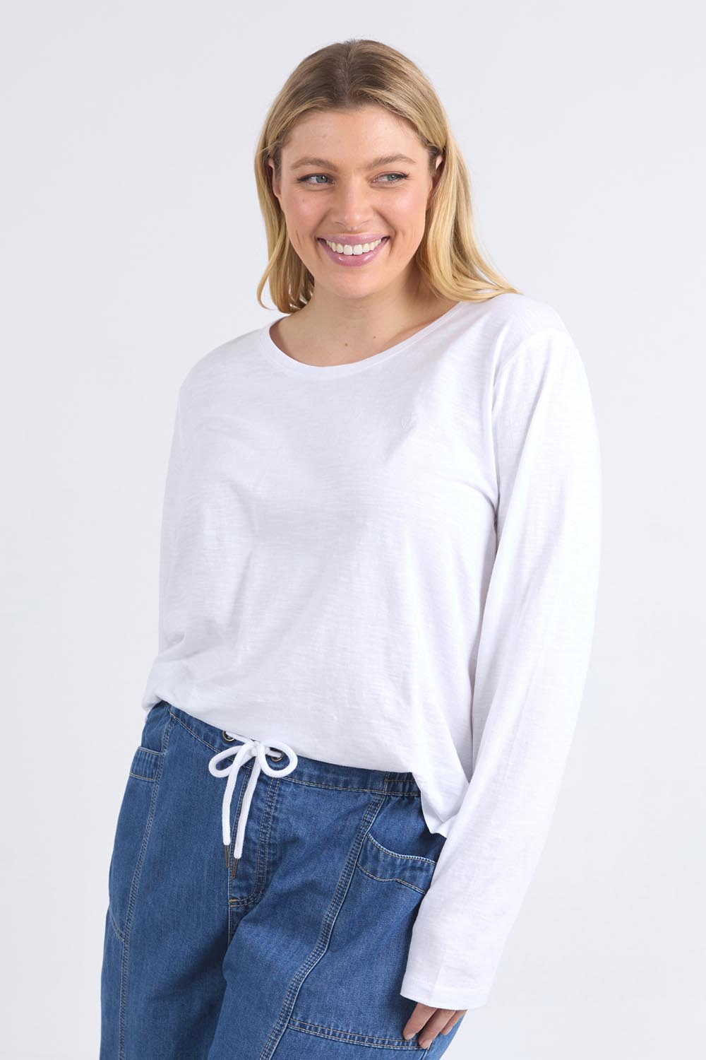 A model wearing the Fundamental Everyday Cotton Long Sleeve Tee in colour White (White), from the front, cropped image