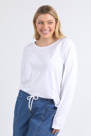 A model wearing the Fundamental Everyday Cotton Long Sleeve Tee in colour White (White), from the front, cropped image