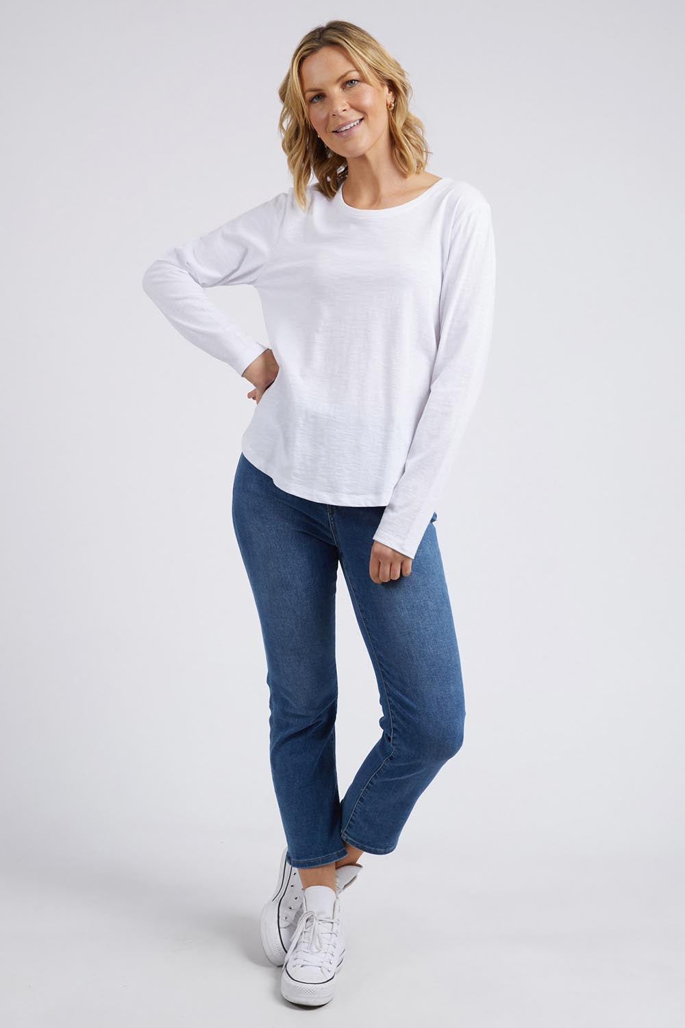 A model wearing the Fundamental Everyday Cotton Long Sleeve Tee in colour White (White), from the front, showing the whole outfit