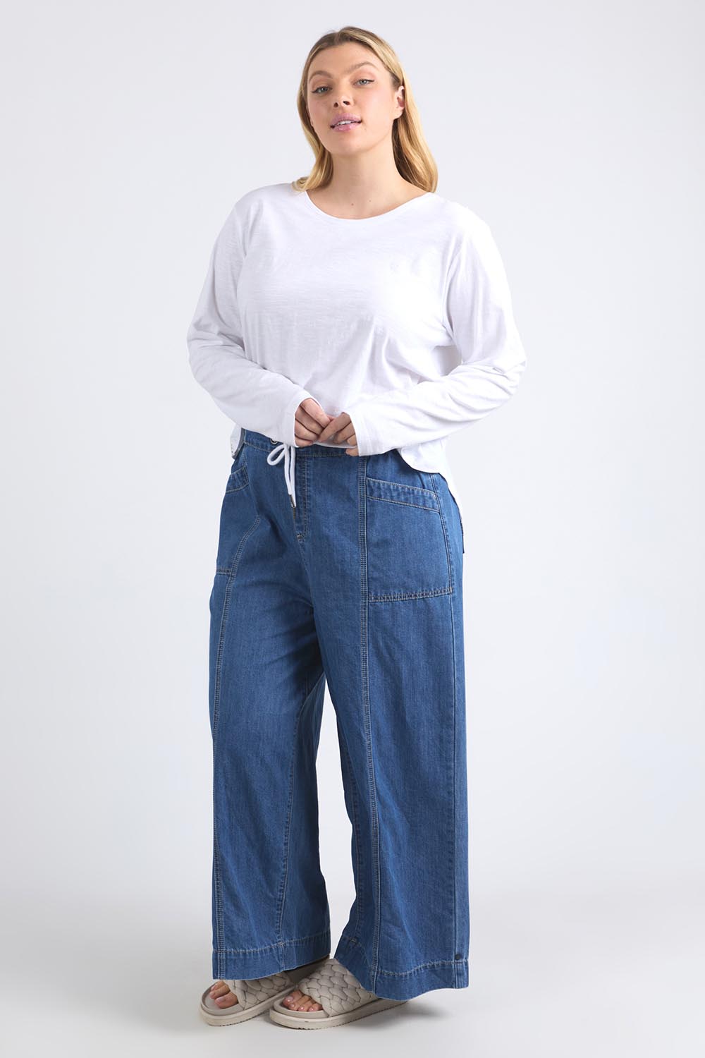 A model wearing the Fundamental Everyday Cotton Long Sleeve Tee in colour White (White), from the front, showing the whole outfit