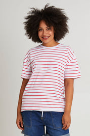 Model Olivia wearing size 10 of the Fundamental Winona Stripe Cotton Tee in colour Redwhite (Red), from the front, cropped image