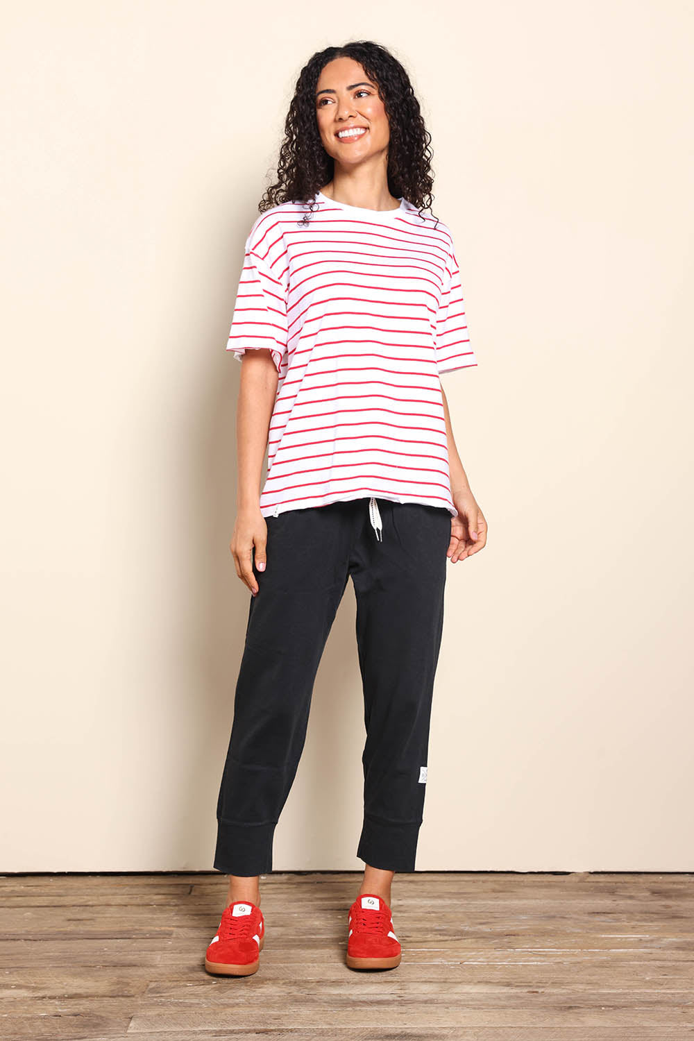 Model Pamelar wearing size 10 of the Fundamental Winona Stripe Cotton Tee - Redwhite in colour Redwhite, from the front