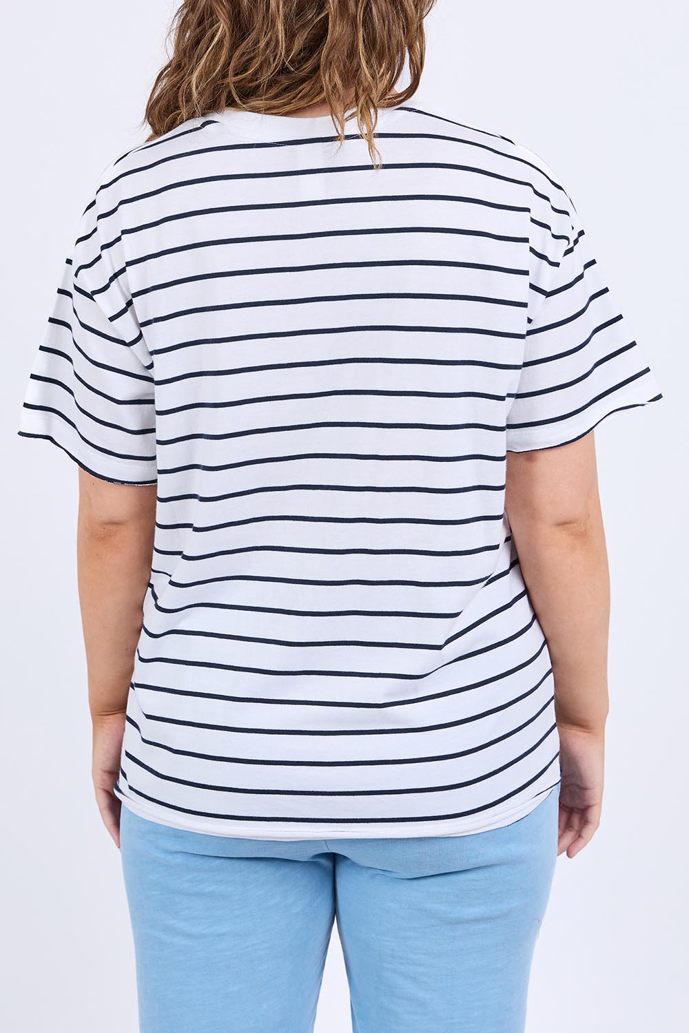 A model wearing the Fundamental Winona Stripe Cotton Tee in colour Whitenavy (White), from the back