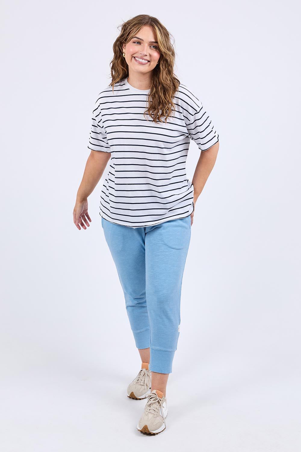 A model wearing the Fundamental Winona Stripe Cotton Tee in colour Whitenavy (White), from the front, showing the whole outfit