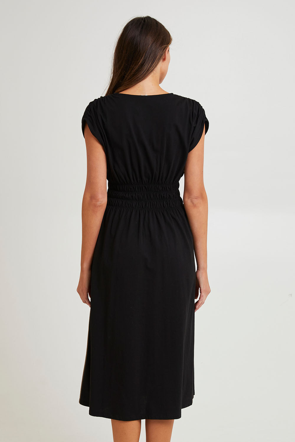 Model Madeline wearing size 10 of the Fundamental Nelle Cotton Midi Dress in colour Black (Black), from the back