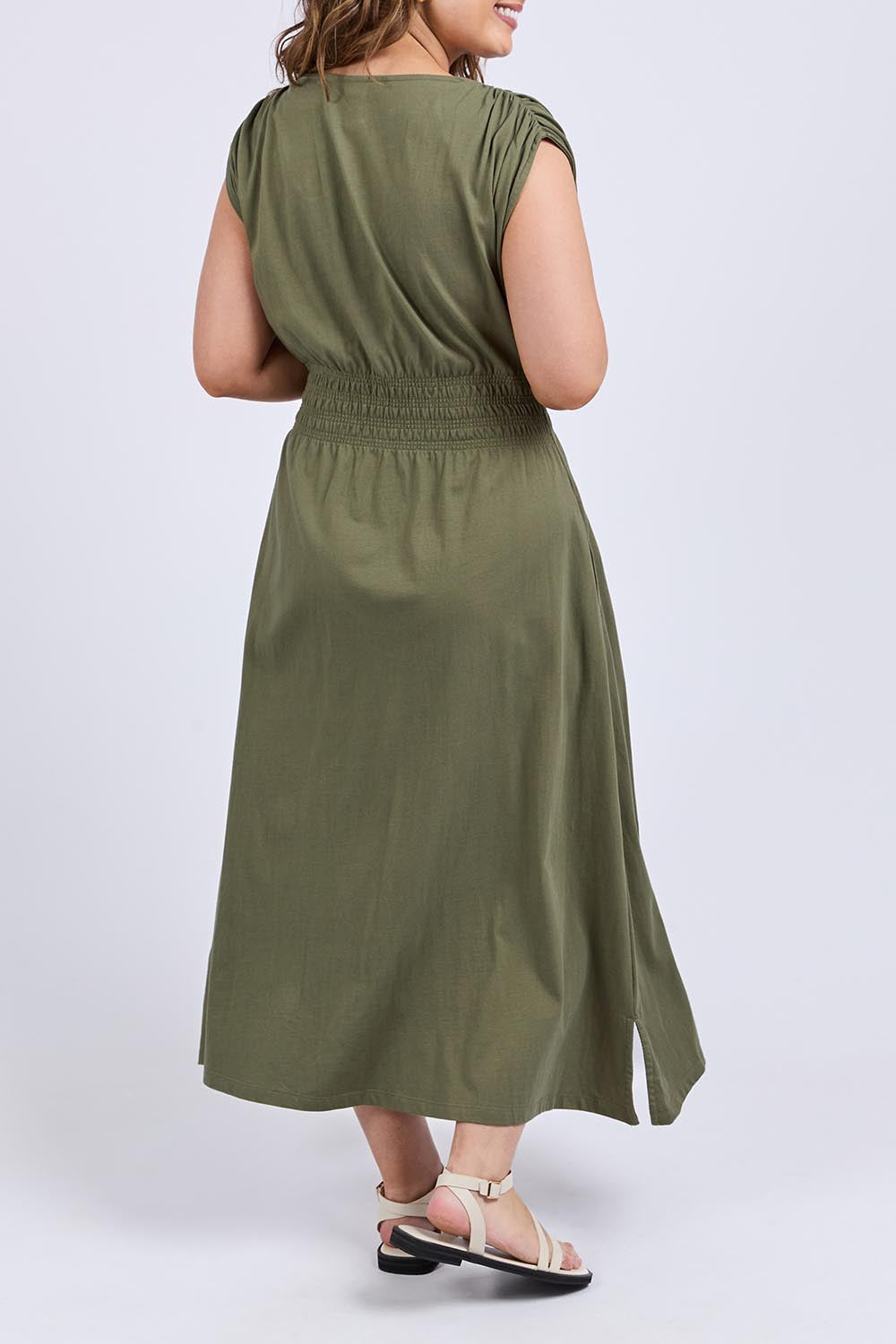 A model wearing the Fundamental Nelle Cotton Midi Dress in colour Clover (Green), from the back
