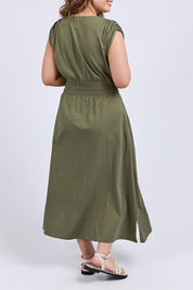 A model wearing the Fundamental Nelle Cotton Midi Dress in colour Clover (Green), from the back