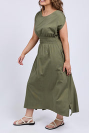 A model wearing the Fundamental Nelle Cotton Midi Dress in colour Clover (Green), from the front, cropped image