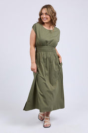 A model wearing the Fundamental Nelle Cotton Midi Dress in colour Clover (Green), from the front, showing the whole outfit