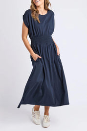 A model wearing the Fundamental Nelle Cotton Midi Dress in colour Navy (Blue), from the front, cropped image