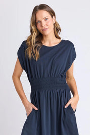 A model wearing the Fundamental Nelle Cotton Midi Dress in colour Navy (Blue), from the front, cropped image