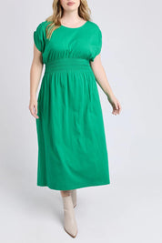 A model wearing the Fundamental Nelle Cotton Midi Dress in colour Pinegreen (Green), from the front, cropped image