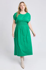 A model wearing the Fundamental Nelle Cotton Midi Dress in colour Pinegreen (Green), from the front, showing the whole outfit