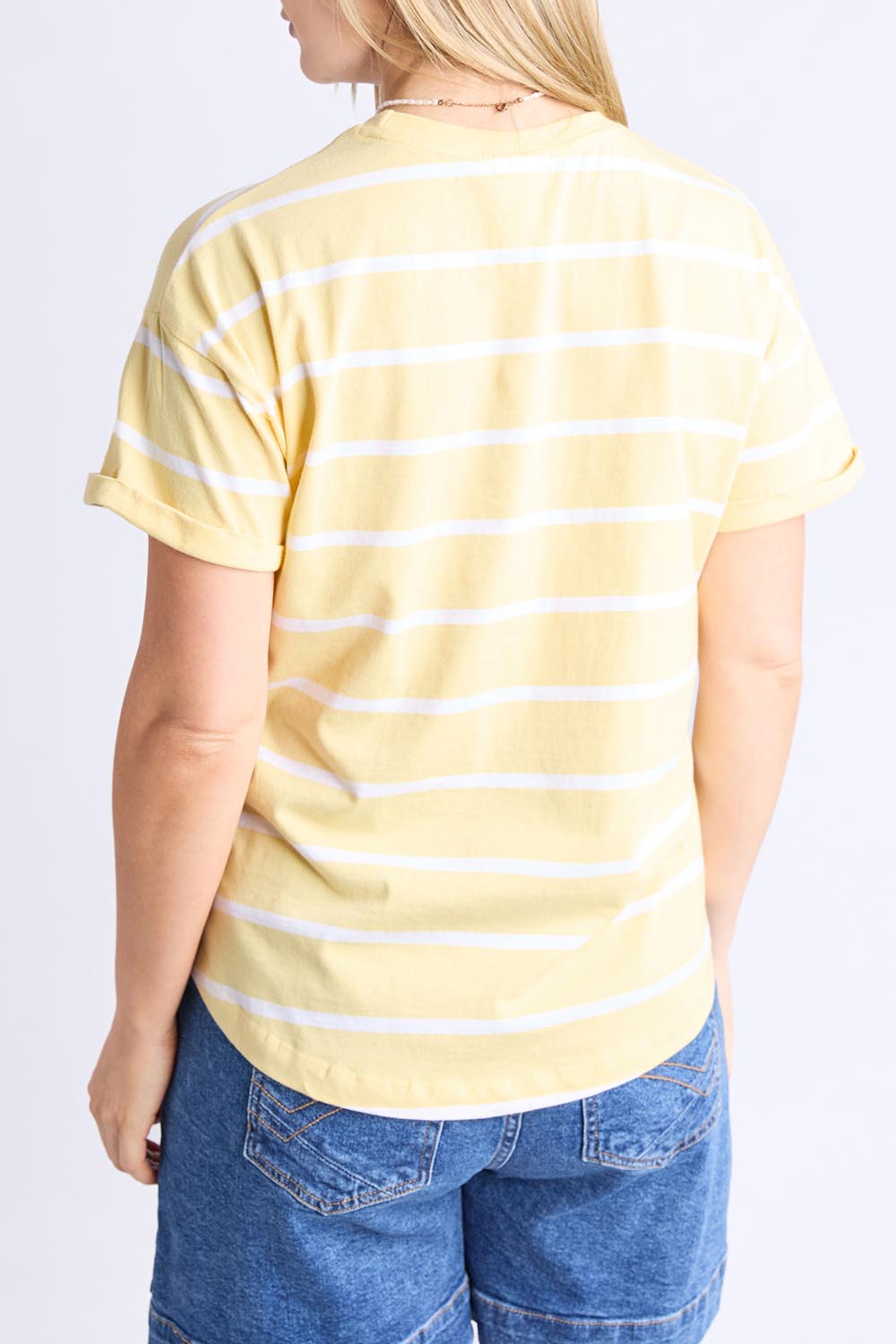 A model wearing the Fundamental Halli Cotton Short Sleeve Tee in colour Bananast, from the back