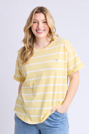 A model wearing the Fundamental Halli Cotton Short Sleeve Tee in colour Bananast, from the front, cropped image
