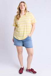 A model wearing the Fundamental Halli Cotton Short Sleeve Tee in colour Bananast, from the front, showing the whole outfit