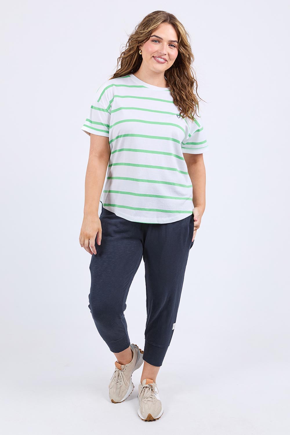 A model wearing the Fundamental Halli Cotton Short Sleeve Tee in colour Whitegreen (White), from the front, showing the whole outfit