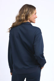 A model wearing the Fundamental Tatum Half Zip Cotton Blend Sweat in colour Navy (Blue), from the back