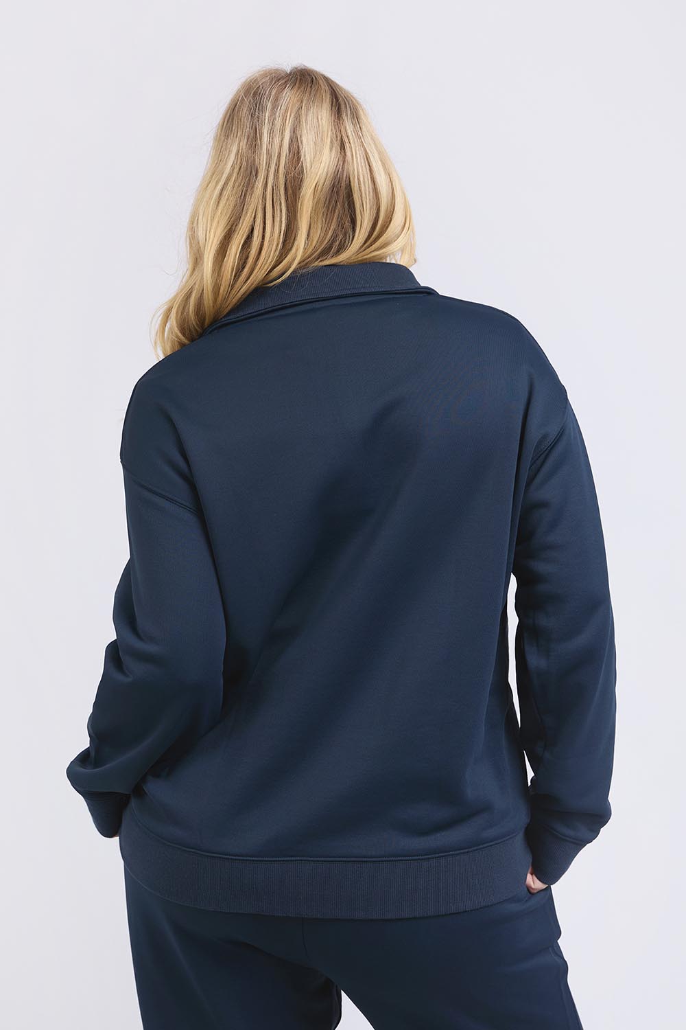 A model wearing the Fundamental Tatum Half Zip Cotton Blend Sweat in colour Navy (Blue), from the back