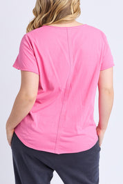 A model wearing the Fundamental Pima Cotton Vee Tee in colour Audorapink (Pink), from the back