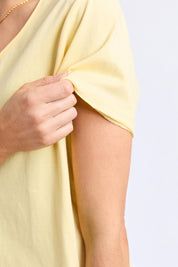 A model wearing the Fundamental Pima Cotton Vee Tee in colour Banana, from the front, cropped image