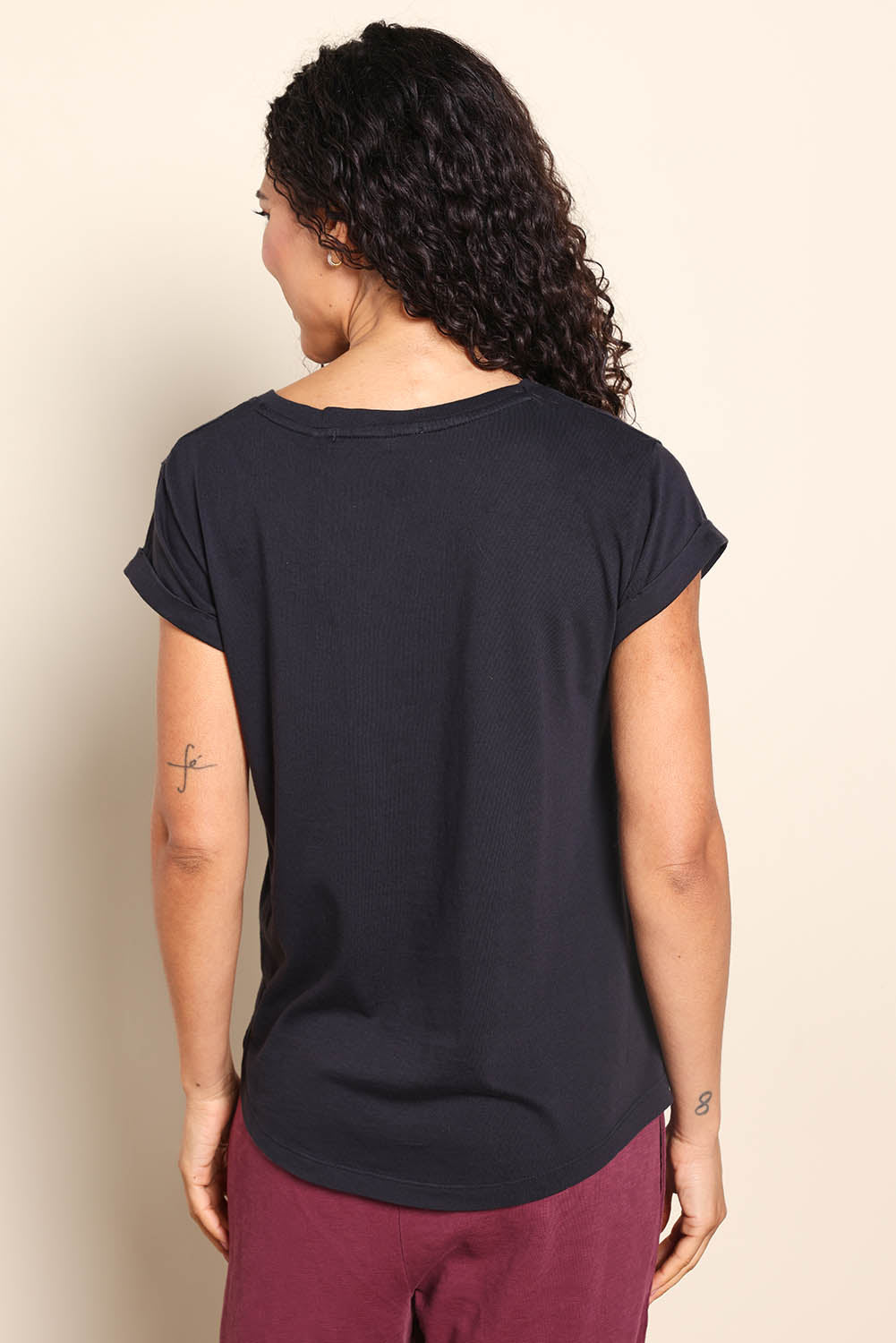 Model Pamelar wearing size 10 of the Fundamental Pima Cotton Vee Tee - Black in colour Black, from the back