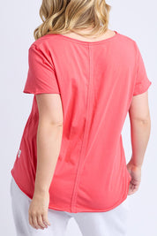 A model wearing the Fundamental Pima Cotton Vee Tee in colour Cayenne (Red), from the back