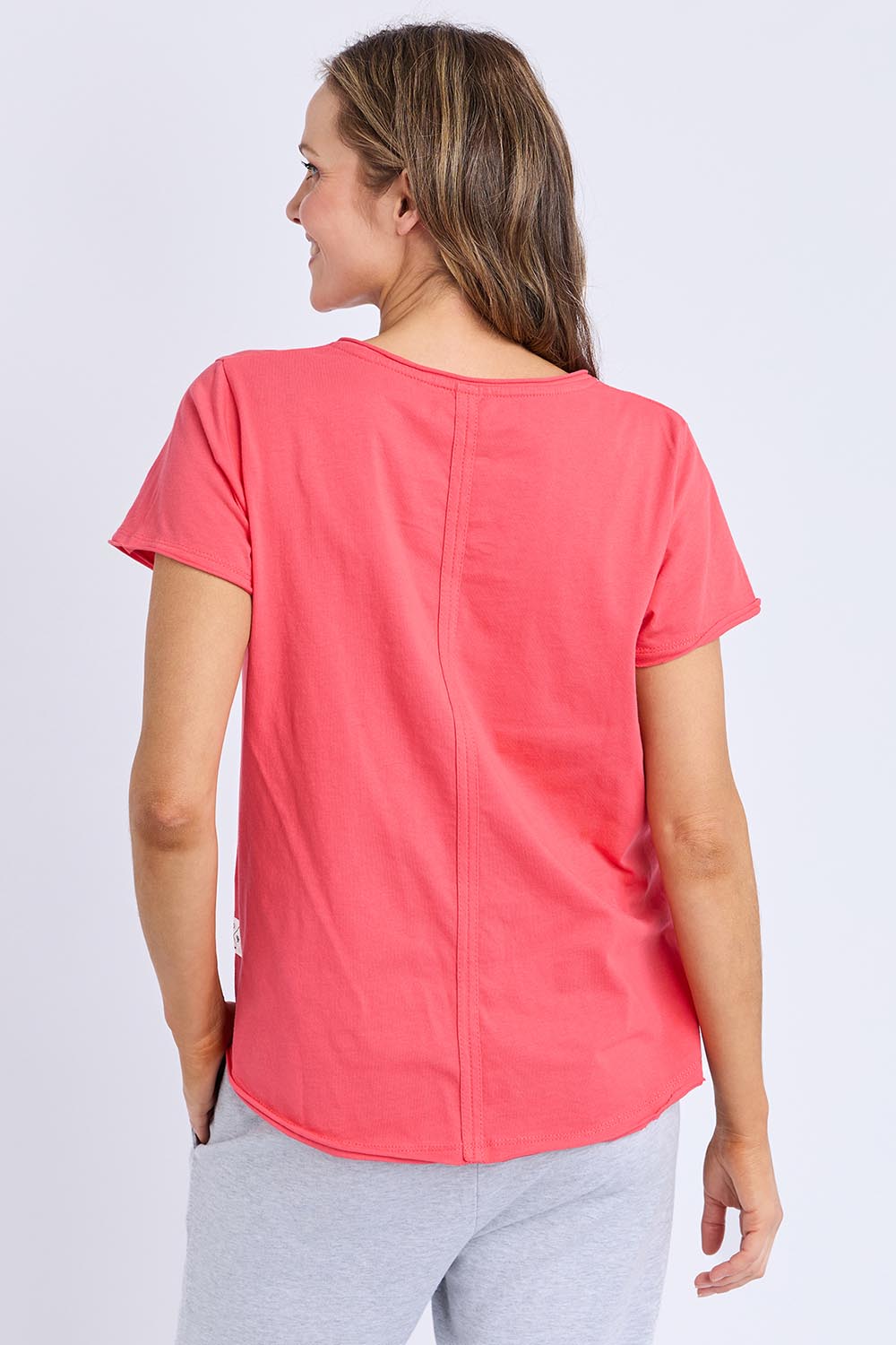 A model wearing the Fundamental Pima Cotton Vee Tee in colour Cayenne (Red), from the back