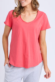 A model wearing the Fundamental Pima Cotton Vee Tee in colour Cayenne (Red), from the front, cropped image