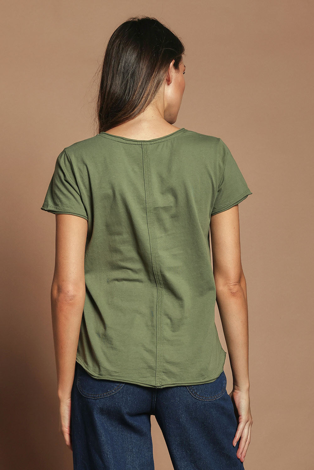 Model Madeline wearing size 10 of the Fundamental Pima Cotton Vee Tee in colour Khaki (Green), from the back