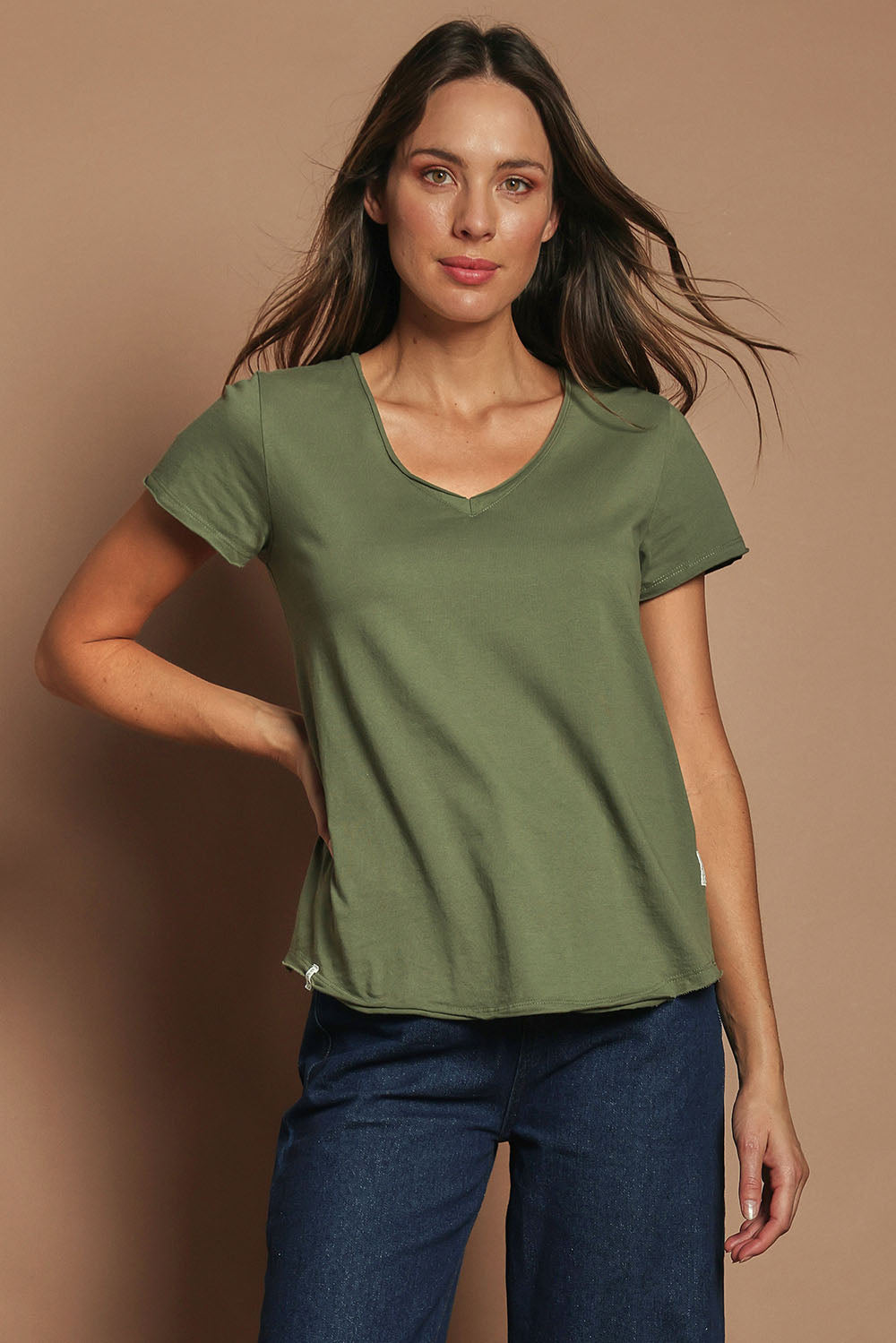 Model Madeline wearing size 10 of the Fundamental Pima Cotton Vee Tee in colour Khaki (Green), from the front, cropped image