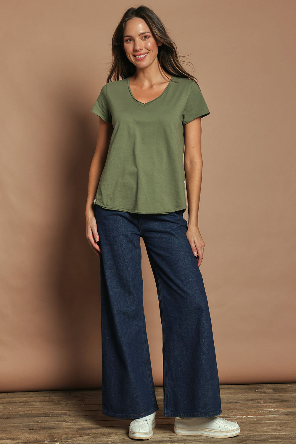 Model Madeline wearing size 10 of the Fundamental Pima Cotton Vee Tee in colour Khaki (Green), from the front, showing the whole outfit