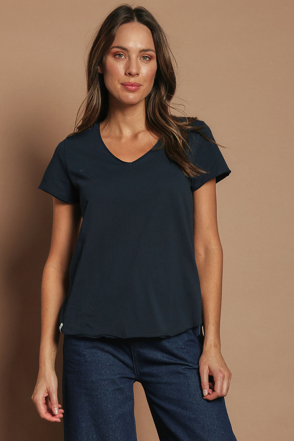 Model Madeline wearing size 10 of the Fundamental Pima Cotton Vee Tee in colour Navy (Blue), from the front, cropped image