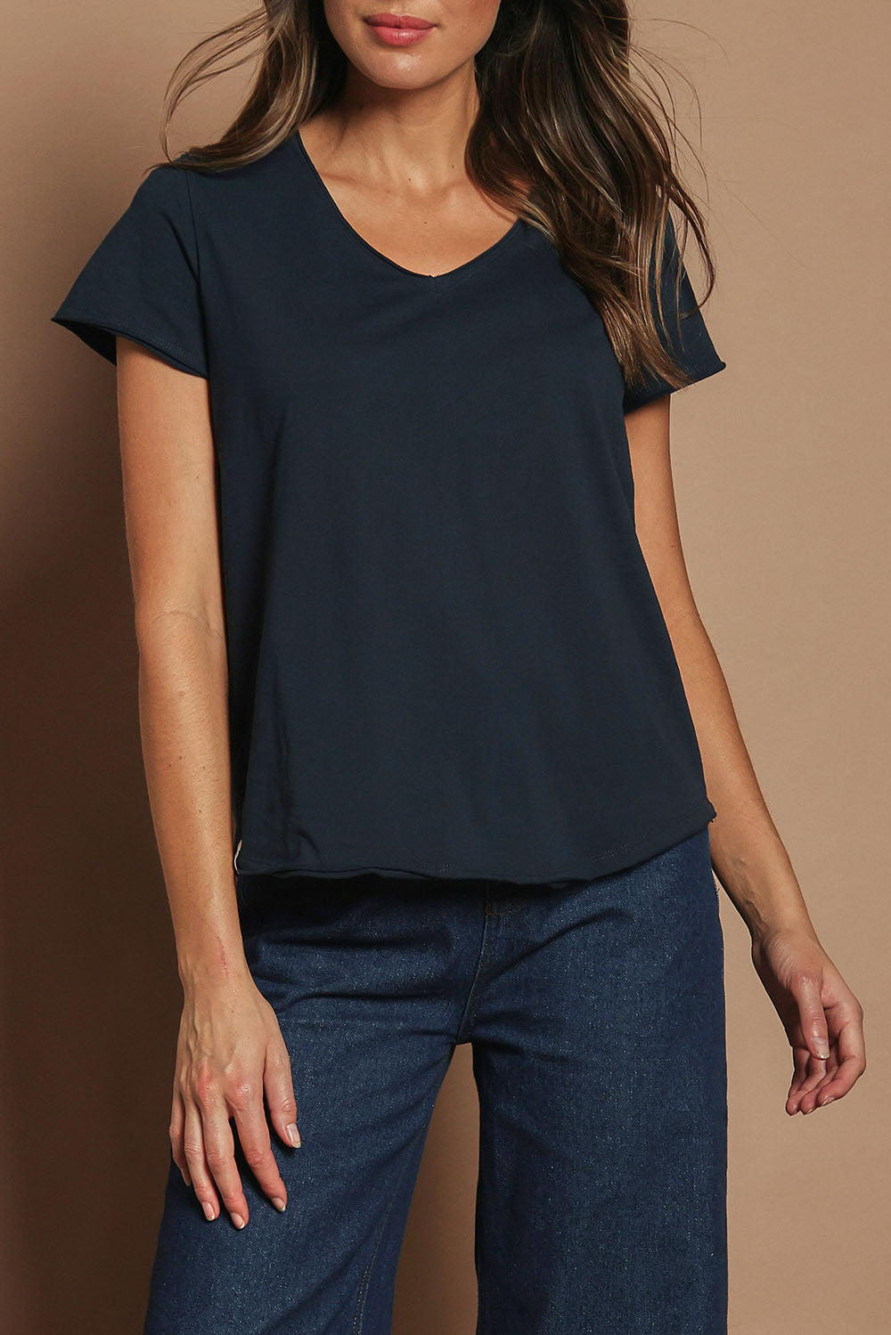 Model Madeline wearing size 10 of the Fundamental Pima Cotton Vee Tee in colour Navy (Blue), from the front, cropped image