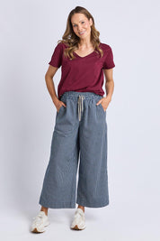 A model wearing the Fundamental Pima Cotton Vee Tee in colour Plum (Purple), from the front, showing the whole outfit