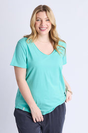 A model wearing the Fundamental Pima Cotton Vee Tee in colour Poolblue (Blue), from the front, cropped image