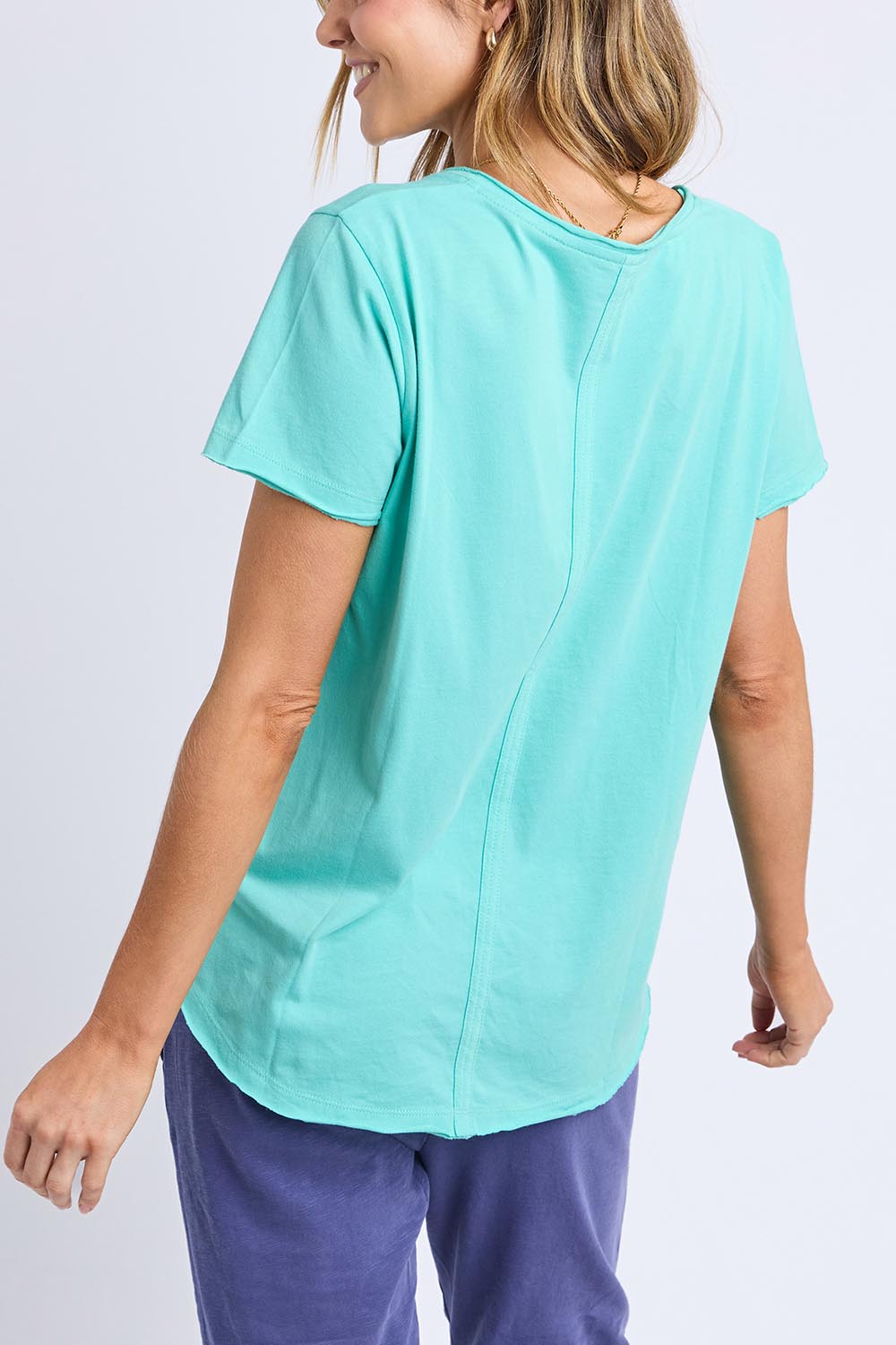 A model wearing the Fundamental Pima Cotton Vee Tee in colour Poolblue (Blue), from the front, cropped image