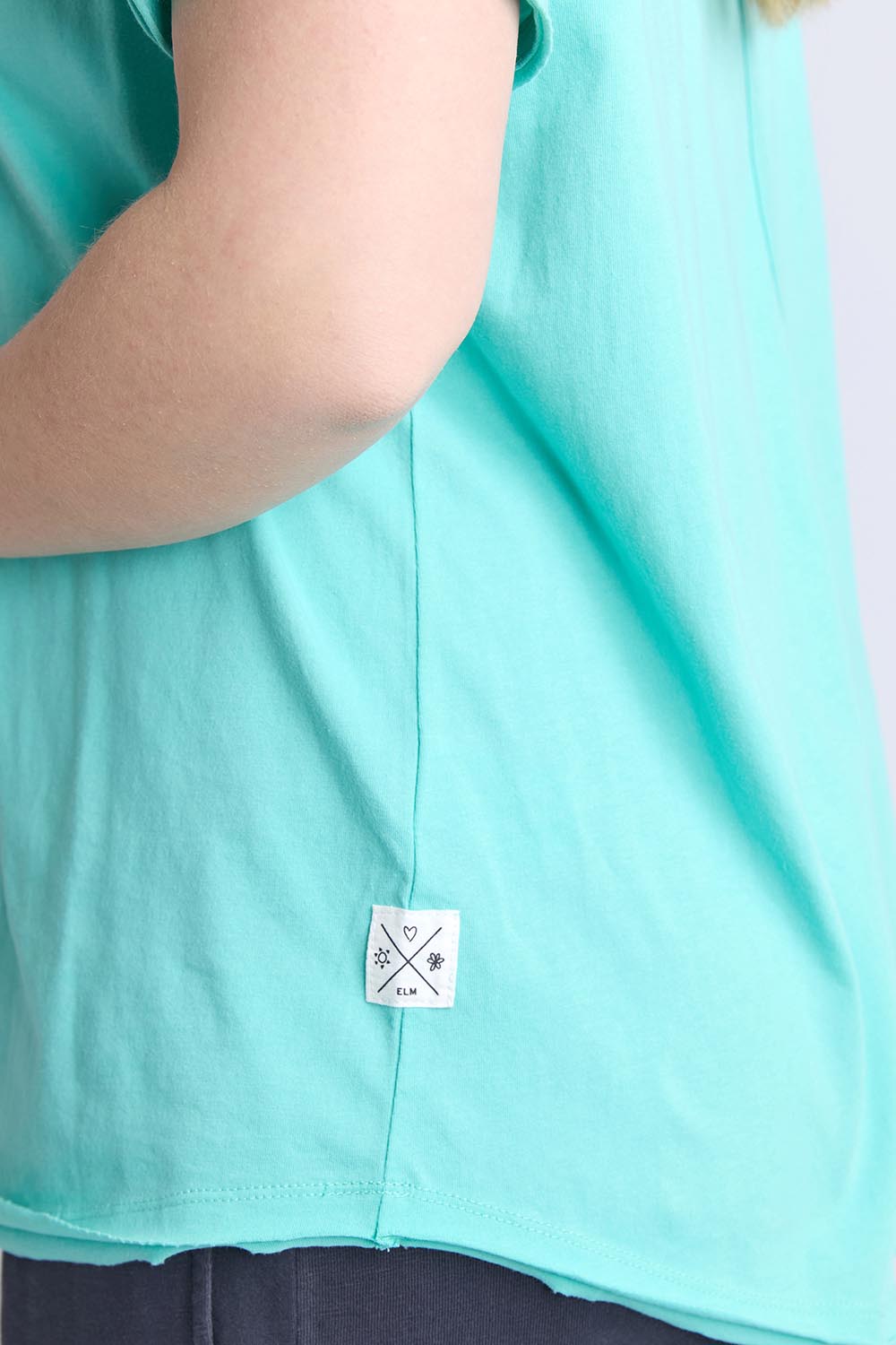 A model wearing the Fundamental Pima Cotton Vee Tee in colour Poolblue (Blue), from the front, cropped image