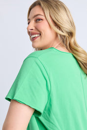 A model wearing the Fundamental Pima Cotton Vee Tee in colour Springgree (Green), from the front, cropped image