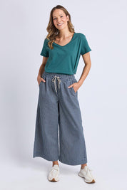 A model wearing the Fundamental Pima Cotton Vee Tee in colour Teal (Green), from the front, showing the whole outfit