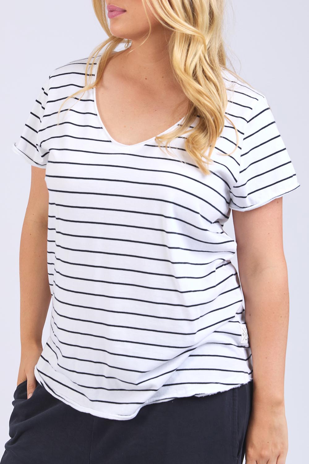 A model wearing the Fundamental Pima Cotton Stripe Vee Tee in colour Whitenavy (White), from the front, cropped image