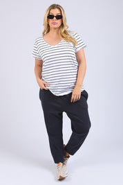 A model wearing the Fundamental Pima Cotton Stripe Vee Tee in colour Whitenavy (White), from the front, showing the whole outfit