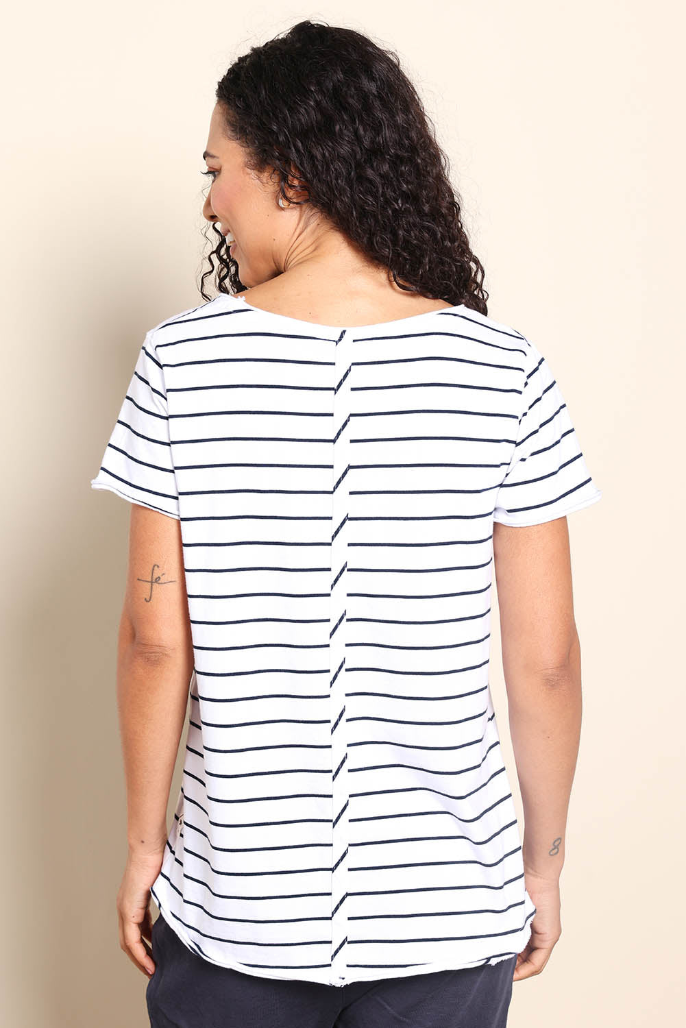 Model Pamelar wearing size 10 of the Fundamental Pima Cotton Stripe Vee Tee - Whitenavy in colour Whitenavy, from the back
