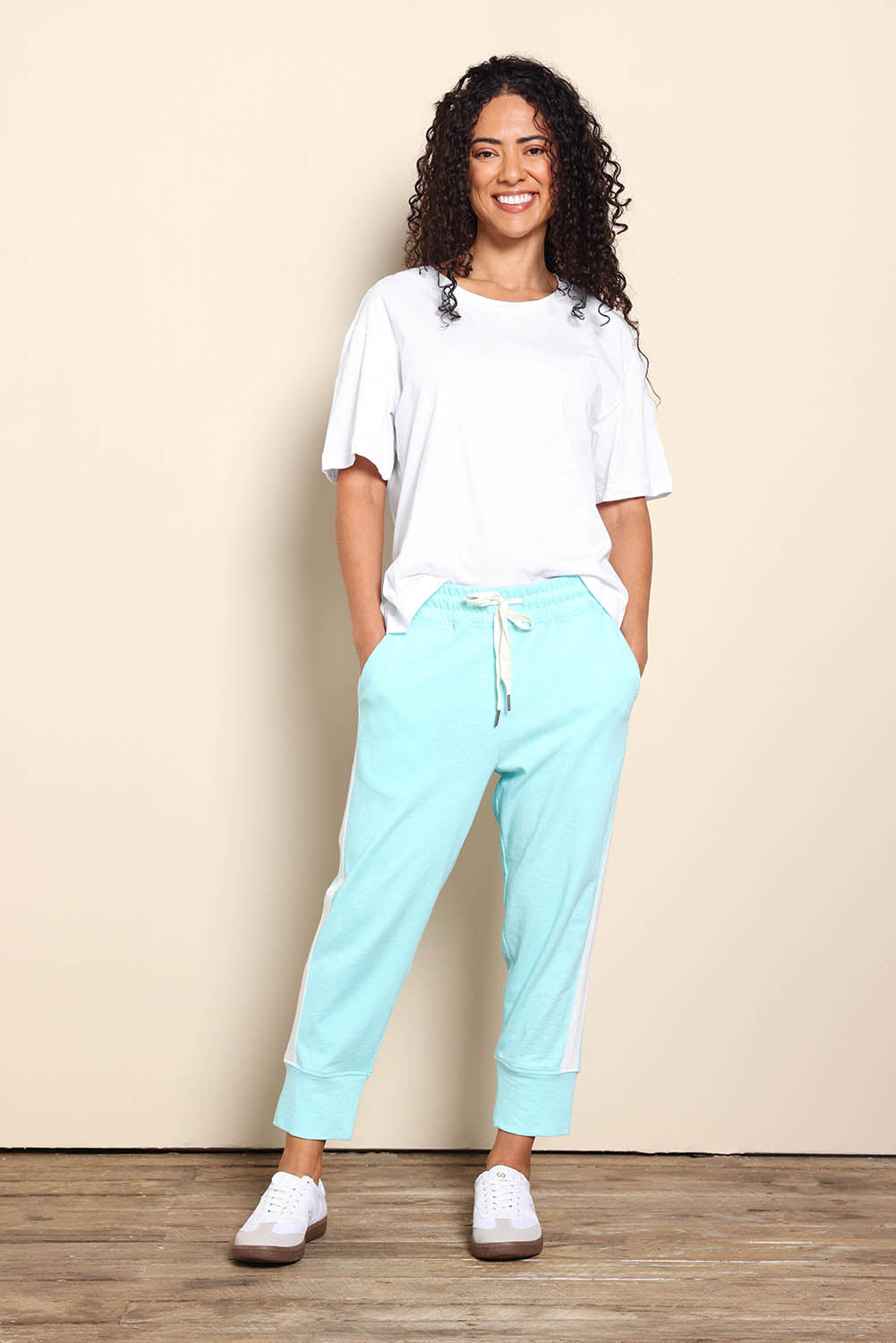 Model Pamelar wearing size 10 of the Fundamental Brunch Cotton Side Tape Pant – Tonicblue in colour Tonicblue, from the front