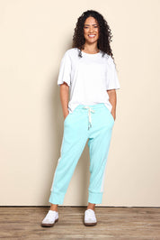Model Pamelar wearing size 10 of the Fundamental Brunch Cotton Side Tape Pant – Tonicblue in colour Tonicblue, from the front