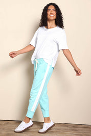Model Pamelar wearing size 10 of the Fundamental Brunch Cotton Side Tape Pant – Tonicblue in colour Tonicblue, from the front