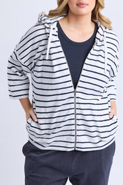 A model wearing the Fundamental Beachy Cotton Hoodie in colour Whitenavy (White), from the front, cropped image