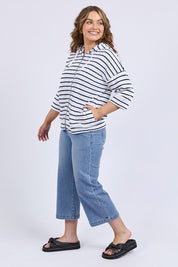 A model wearing the Fundamental Beachy Cotton Hoodie in colour Whitenavy (White), from the front, showing the whole outfit