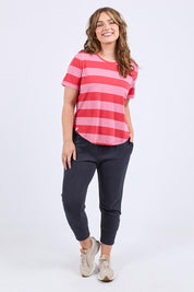 A model wearing the Fundamental Spritz Stripe Ss Cotton Tee in colour Cayennrose (Pink), from the front, showing the whole outfit